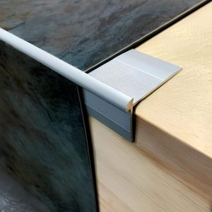 TVC LVT Edge trim detail on wood and stone surfaces.