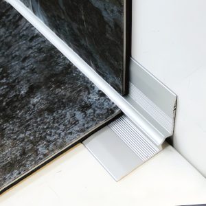 Close-up of tiled floor and wall trim detail inner angle edge